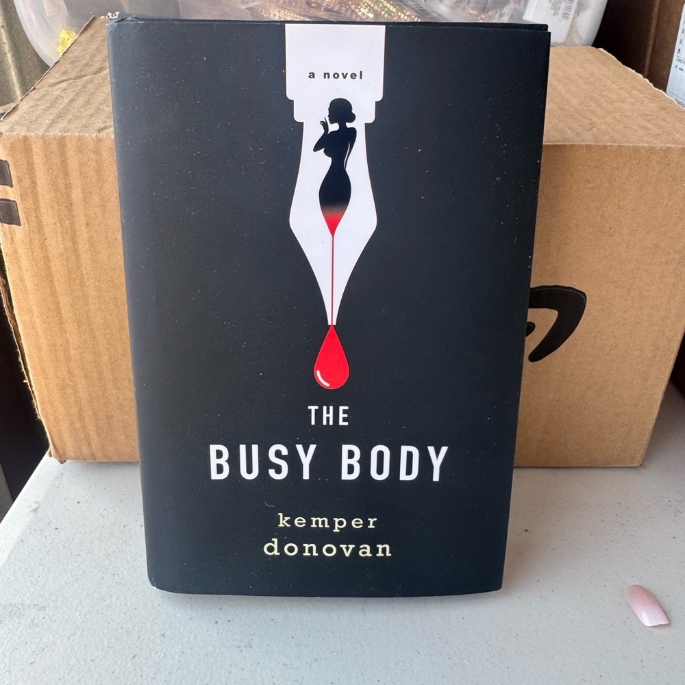 The Busy Body - Black & Red Hardcover Novel